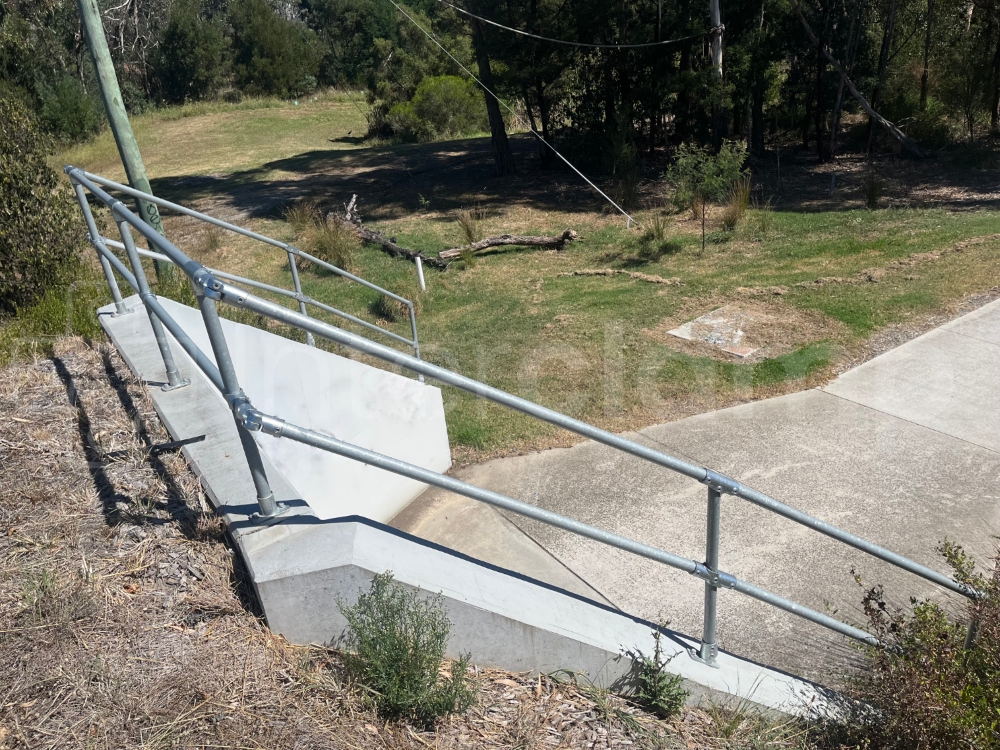 Interclamp galvanised tube clamp fittings used to construct a barrier on culvert wing walls